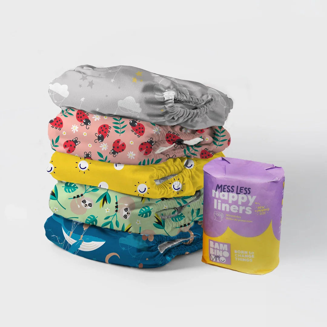 Stack of colorful cloth diapers with a package labeled 'Happy Liners' on a white background