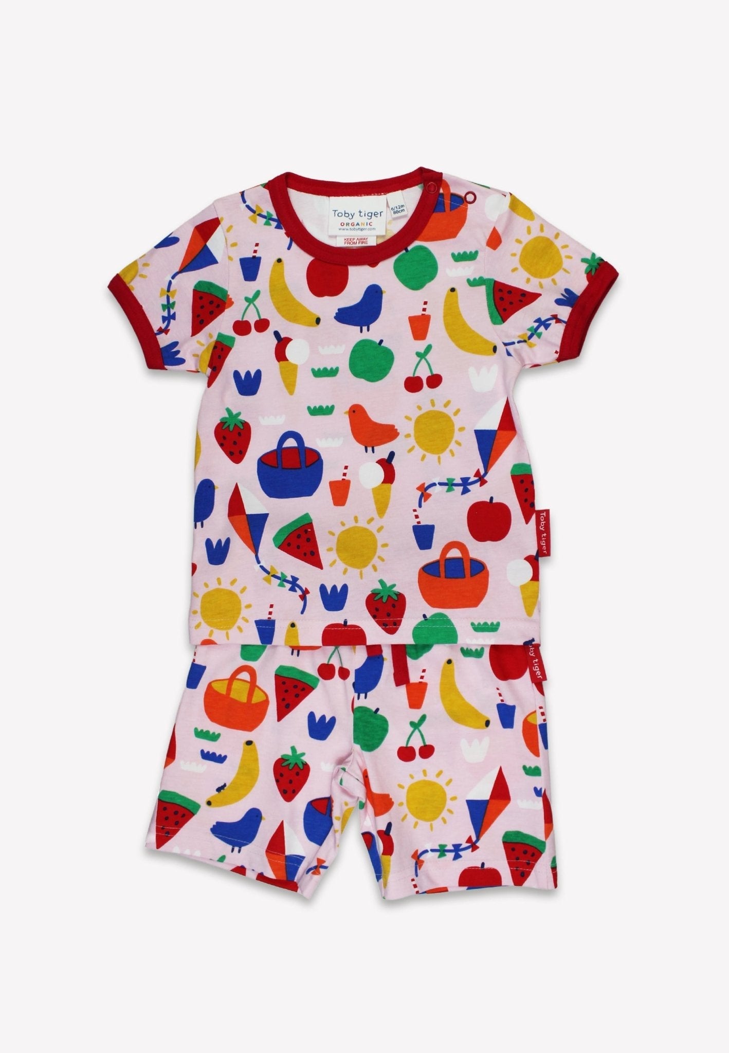 Colorful children's pyjamas with fruit and vegetable pattern on a white background