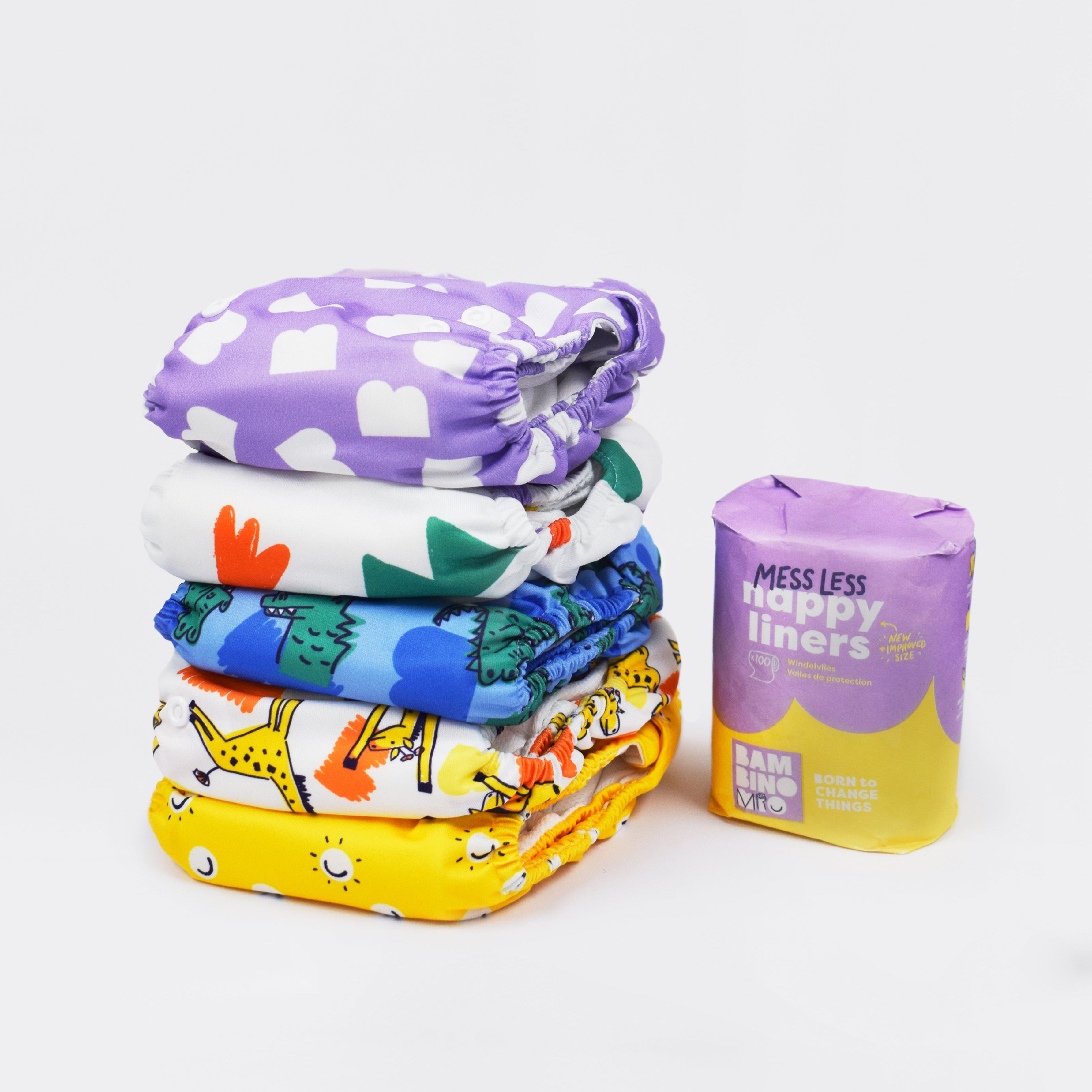 Stack of colorful cloth diapers with a package labeled 'Happy Liners' on a white background