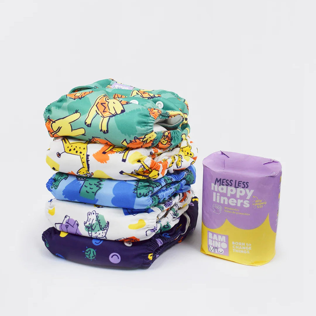 Stack of colorful cloth diapers with a package labeled 'Happy Liners' on a white background