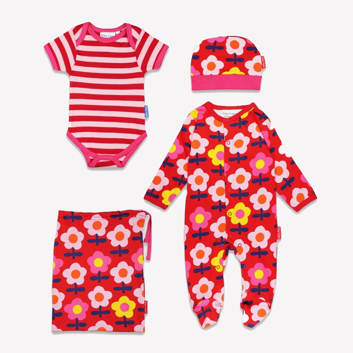 Set of children's clothing including a striped onesie, floral outfit, hat, and bag on a white background.