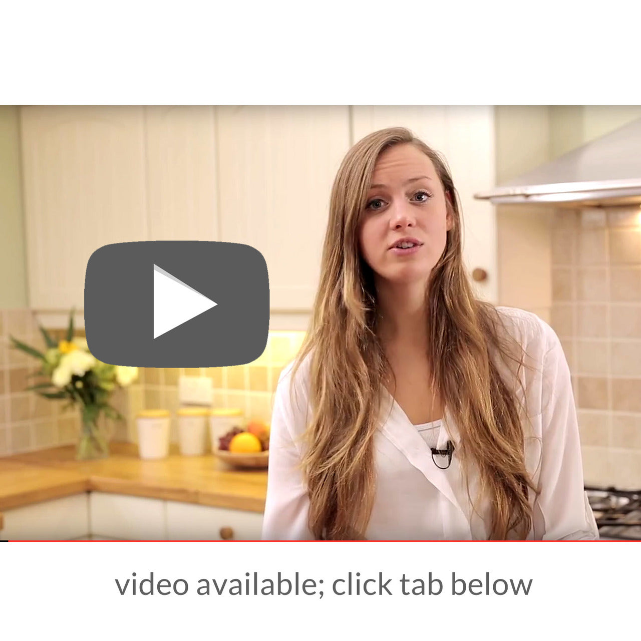 Woman in a kitchen with a play button overlay