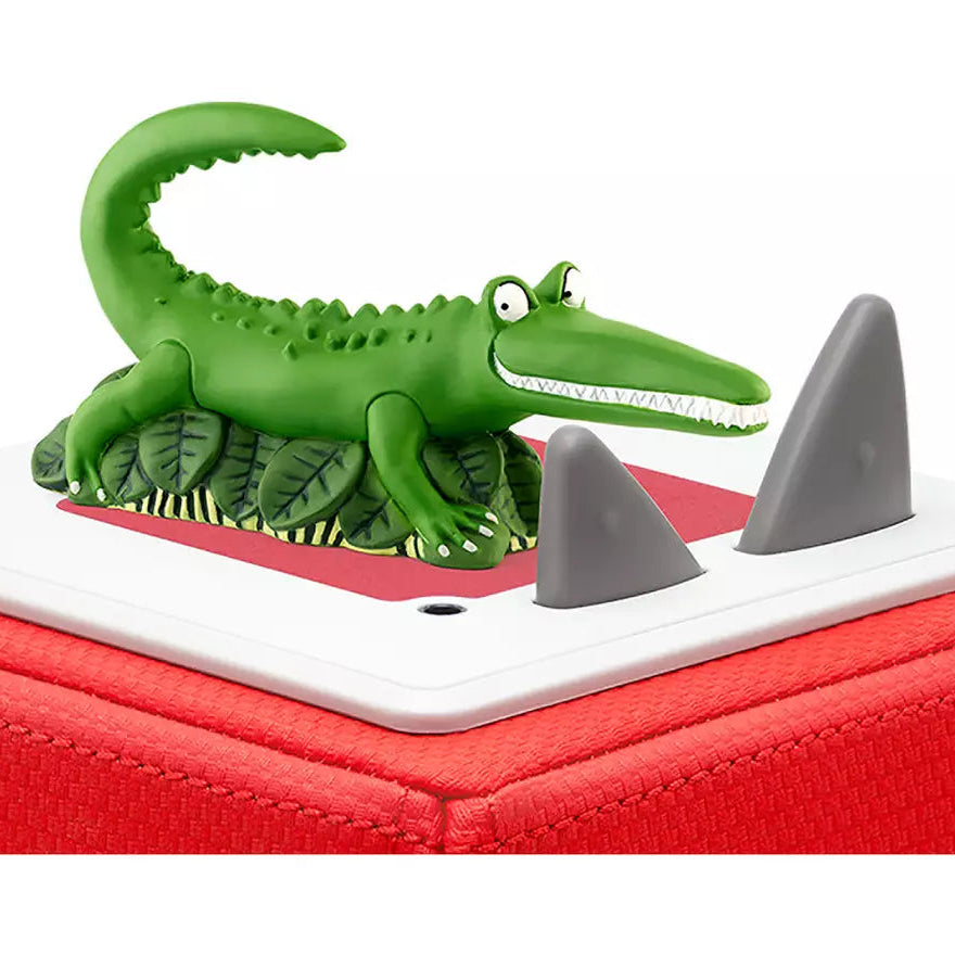 Green alligator toy on a red and white base with shark fins