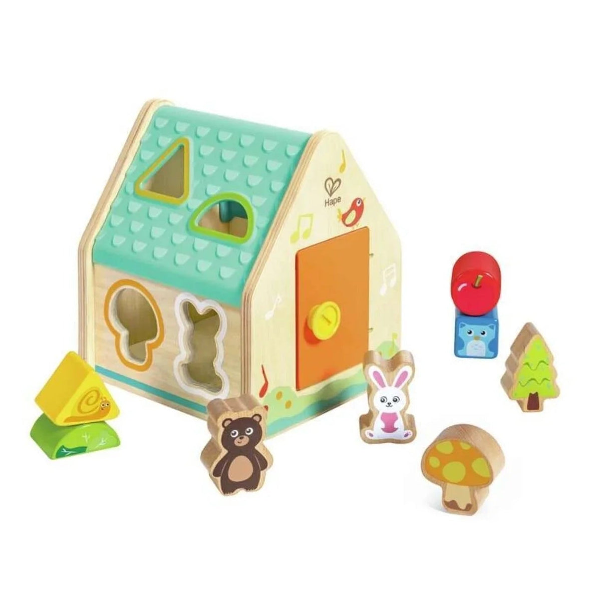 Wooden toy house with various shaped pieces on a white background