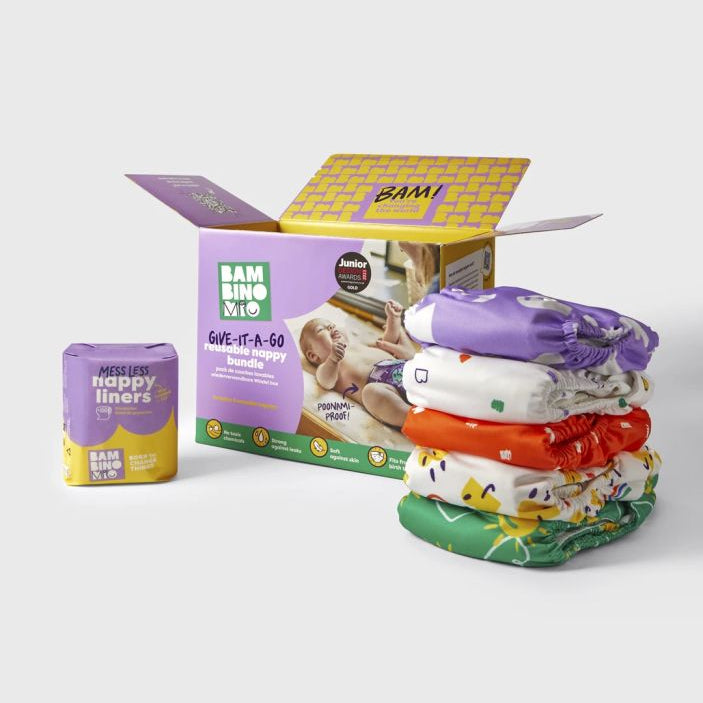 Stack of colorful baby diapers with packaging and product on a white background