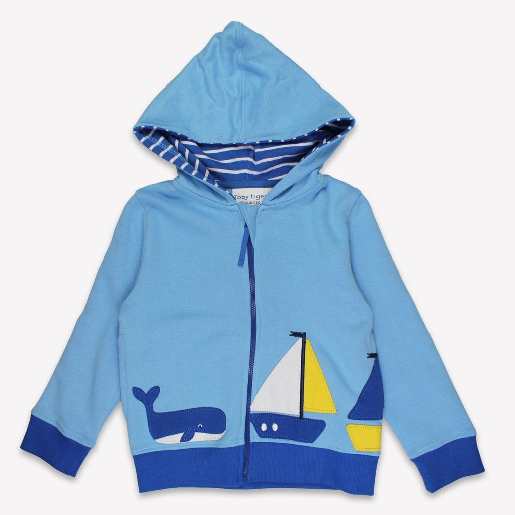 Blue children's hoodie with sailboat and whale designs on a white background