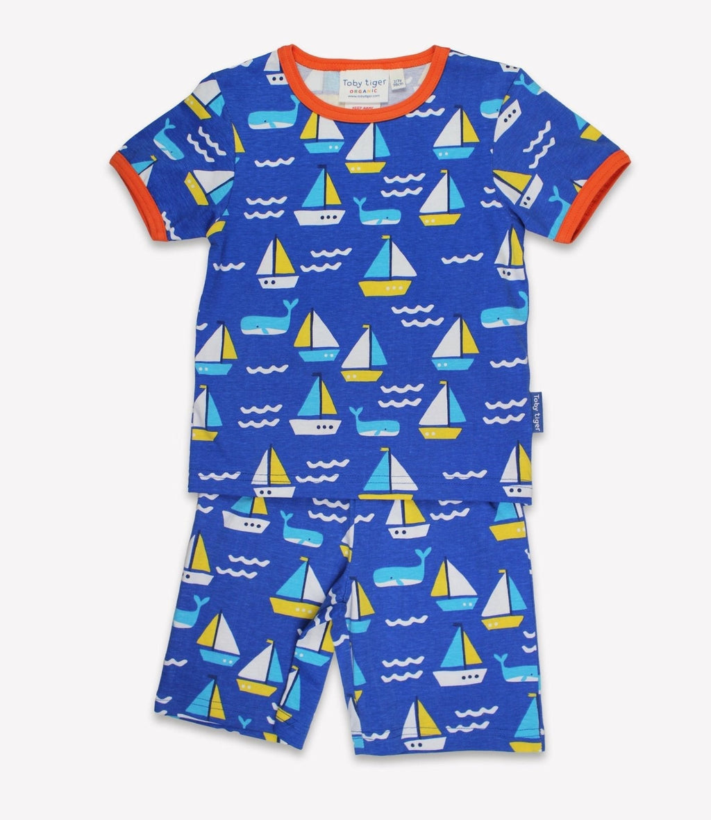 Children's pyjamas with sailboat pattern on a blue background